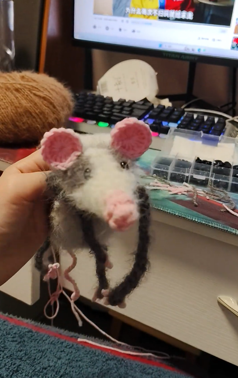 A chubby little mouse with pink ears like a pig