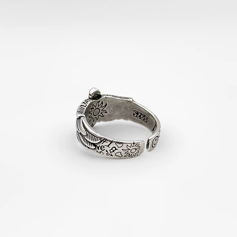 Dark retro winged cross ring