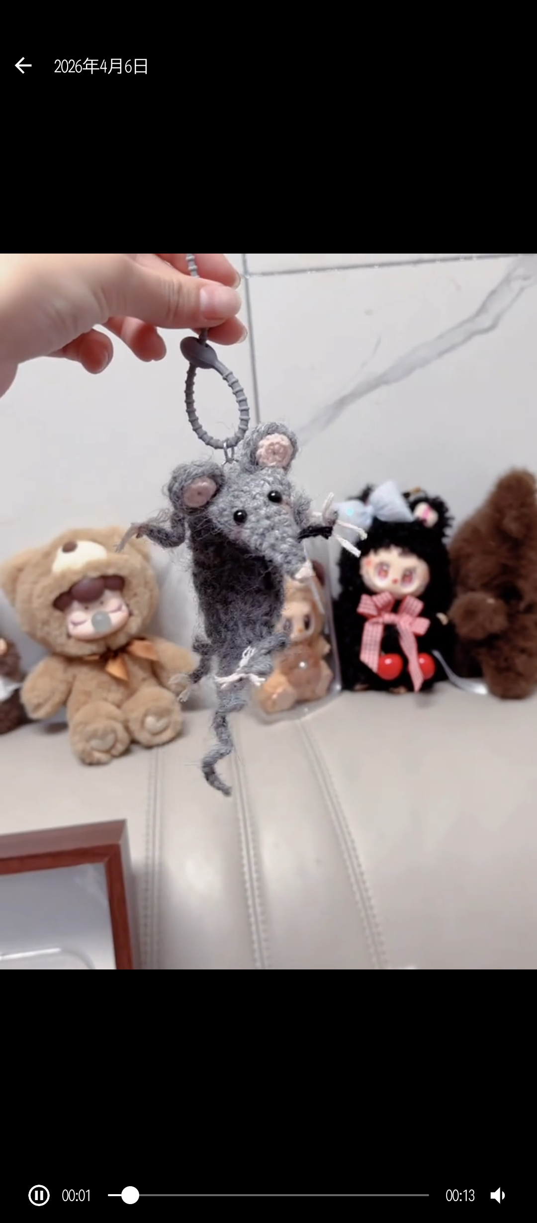 Plastic keychain with gray mouse charm